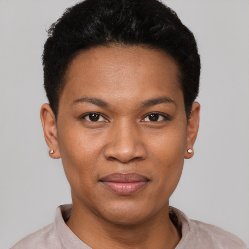 Joyful black young-adult female with short  black hair and brown eyes