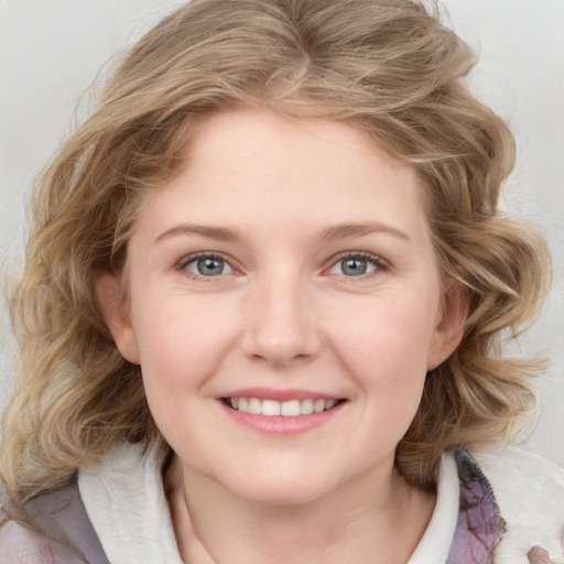 Joyful white young-adult female with medium  brown hair and blue eyes