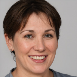 Joyful white adult female with medium  brown hair and brown eyes