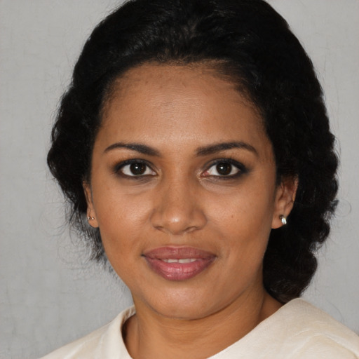 Joyful black young-adult female with short  black hair and brown eyes