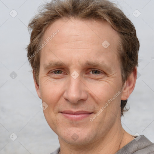 Joyful white adult male with short  brown hair and grey eyes