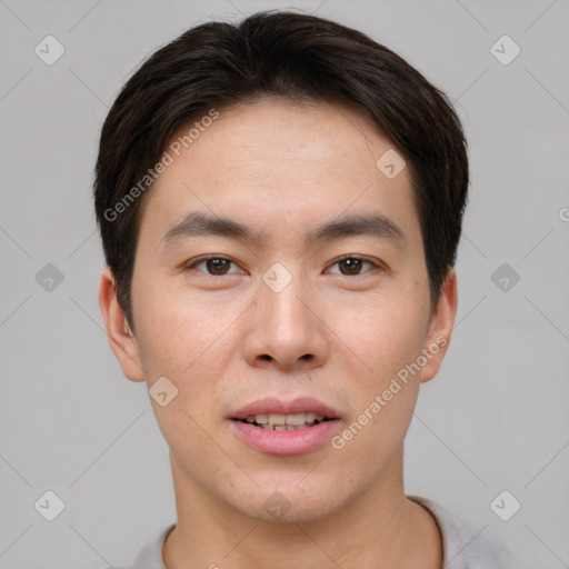 Joyful asian young-adult male with short  brown hair and brown eyes