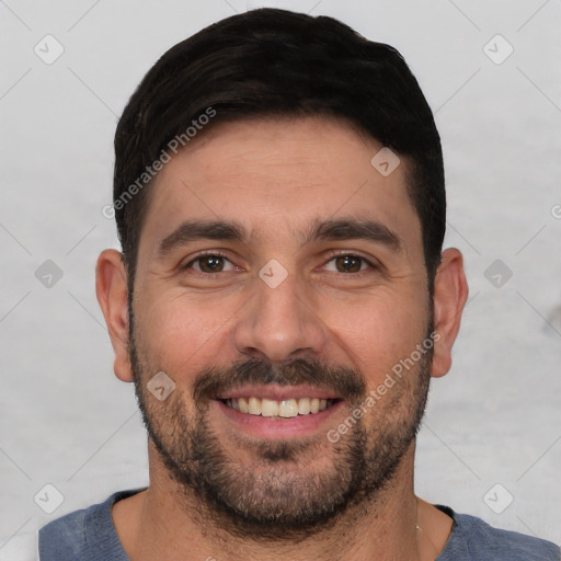 Joyful white young-adult male with short  black hair and brown eyes