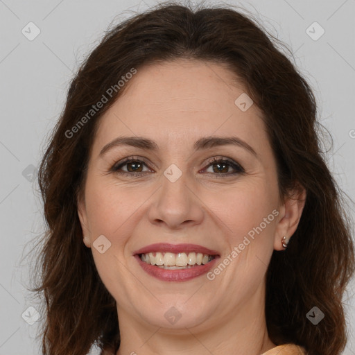 Joyful white adult female with long  brown hair and brown eyes