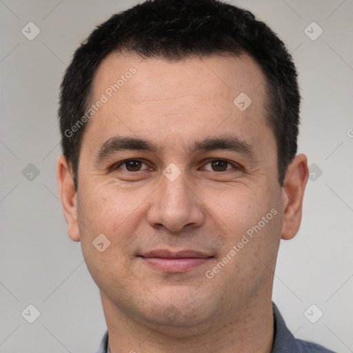 Joyful white adult male with short  brown hair and brown eyes