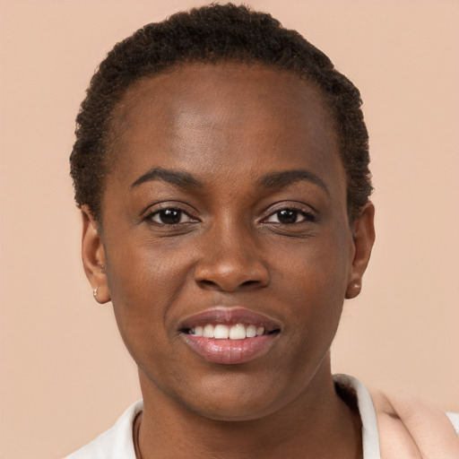 Joyful black young-adult female with short  brown hair and brown eyes