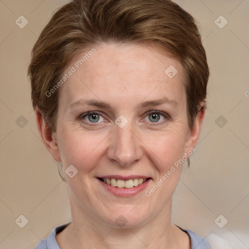 Joyful white adult female with short  brown hair and grey eyes