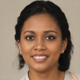 Joyful black young-adult female with medium  brown hair and brown eyes