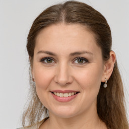 Joyful white young-adult female with long  brown hair and grey eyes