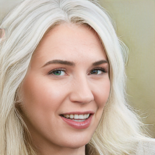 Joyful white young-adult female with long  blond hair and blue eyes