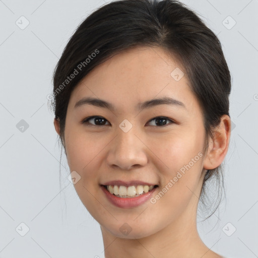 Joyful asian young-adult female with long  brown hair and brown eyes