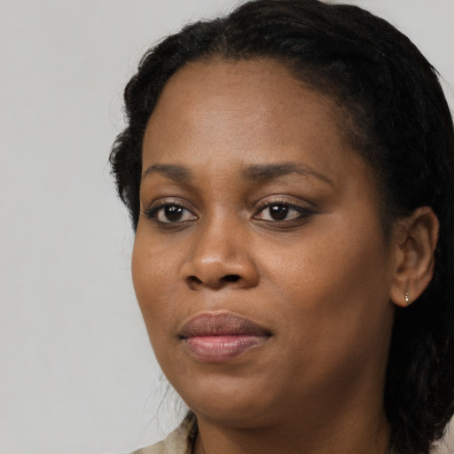 Joyful black young-adult female with medium  black hair and brown eyes