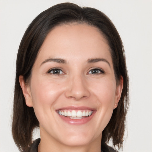 Joyful white young-adult female with medium  brown hair and brown eyes