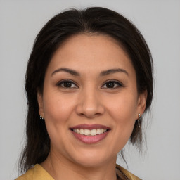 Joyful latino young-adult female with medium  brown hair and brown eyes