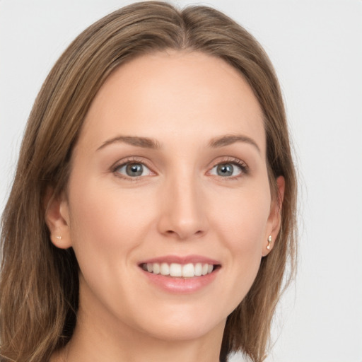 Joyful white young-adult female with long  brown hair and grey eyes