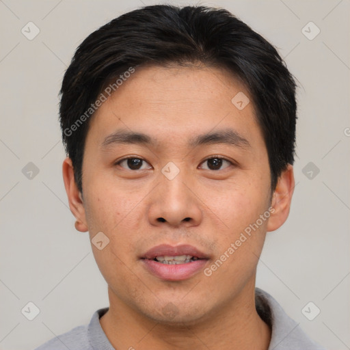 Joyful asian young-adult male with short  brown hair and brown eyes