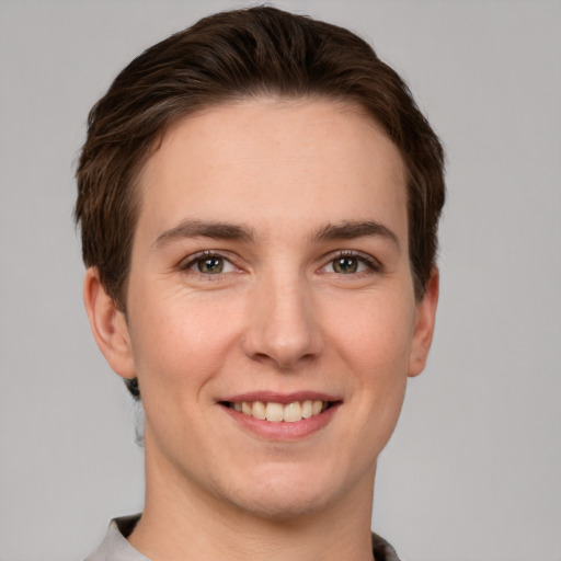 Joyful white young-adult female with short  brown hair and grey eyes