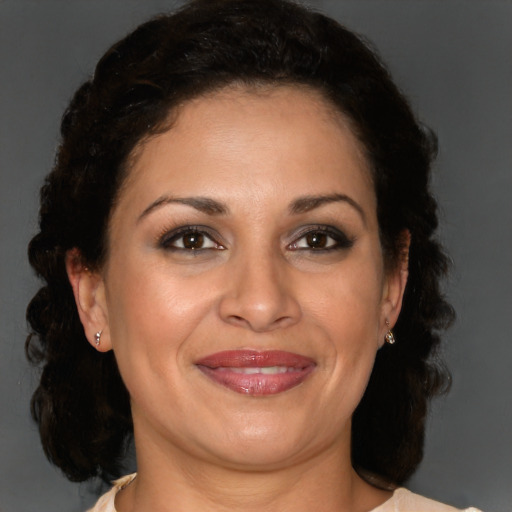 Joyful black adult female with medium  brown hair and brown eyes