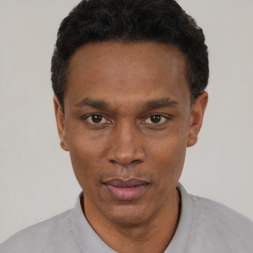 Neutral black adult male with short  black hair and brown eyes