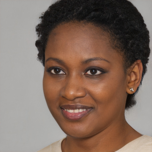 Joyful black young-adult female with short  brown hair and brown eyes