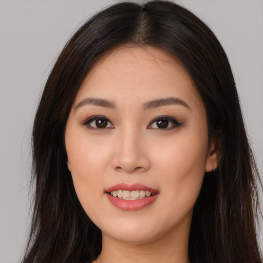 Joyful asian young-adult female with long  brown hair and brown eyes