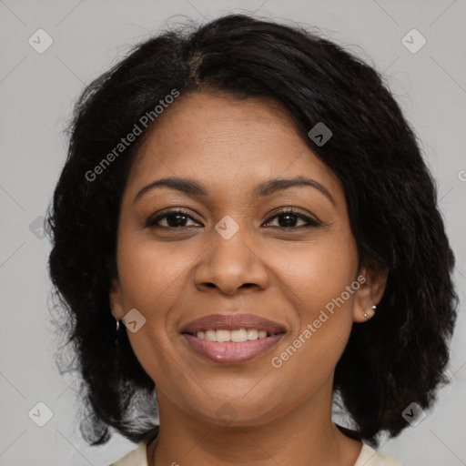 Joyful black adult female with medium  brown hair and brown eyes