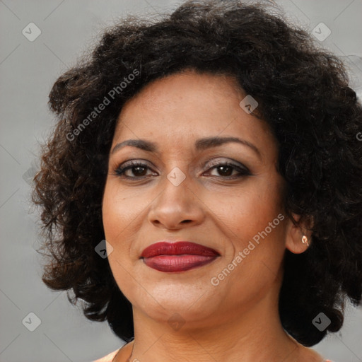 Joyful black adult female with medium  brown hair and brown eyes