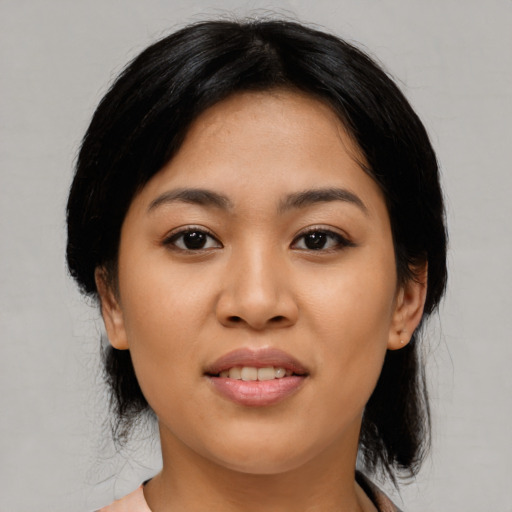 Joyful asian young-adult female with medium  black hair and brown eyes