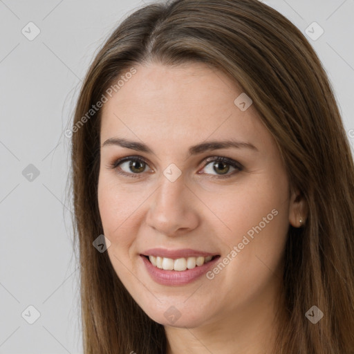 Joyful white young-adult female with long  brown hair and brown eyes