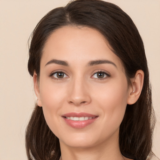 Joyful white young-adult female with long  brown hair and brown eyes