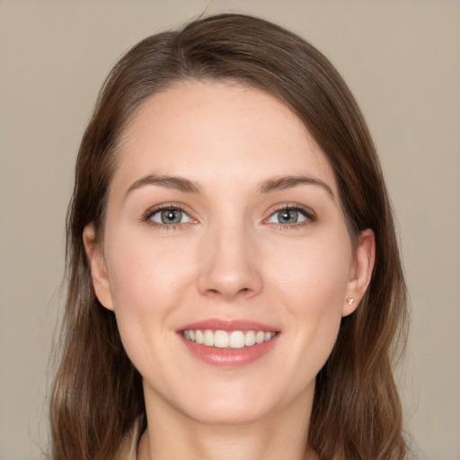 Joyful white young-adult female with long  brown hair and grey eyes