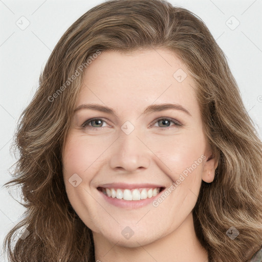 Joyful white young-adult female with long  brown hair and green eyes