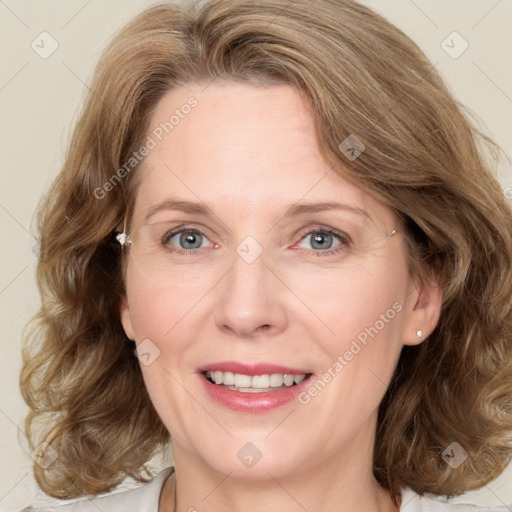 Joyful white adult female with medium  brown hair and blue eyes