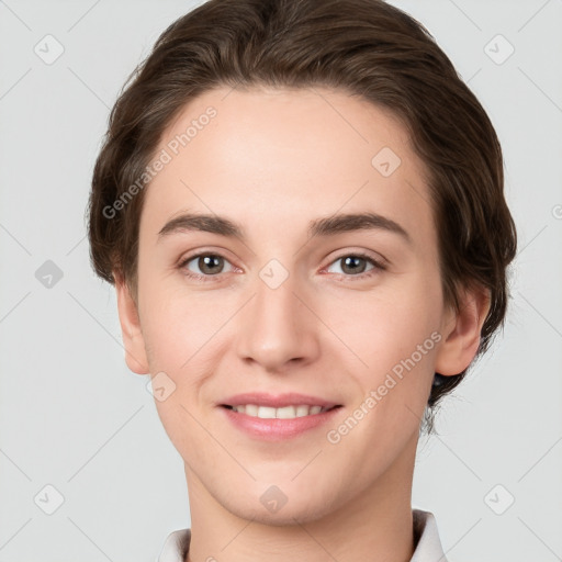 Joyful white young-adult female with short  brown hair and grey eyes