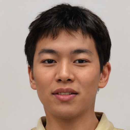 Joyful asian young-adult male with short  brown hair and brown eyes
