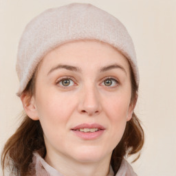 Joyful white young-adult female with medium  brown hair and blue eyes