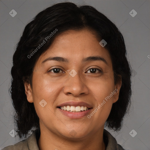 Joyful latino adult female with medium  brown hair and brown eyes