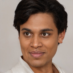 Joyful latino young-adult male with short  brown hair and brown eyes