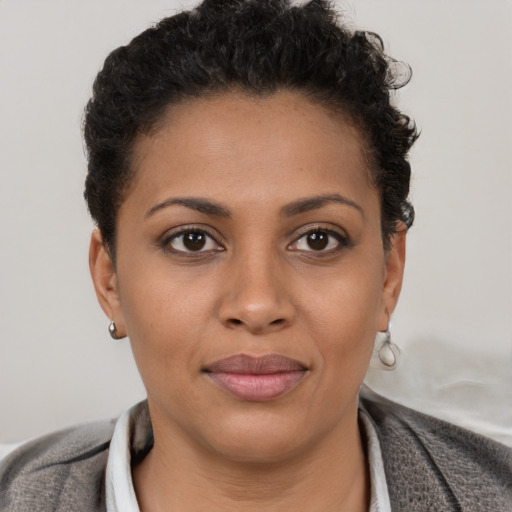 Joyful latino young-adult female with short  brown hair and brown eyes
