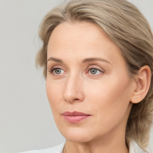 Joyful white adult female with medium  brown hair and blue eyes