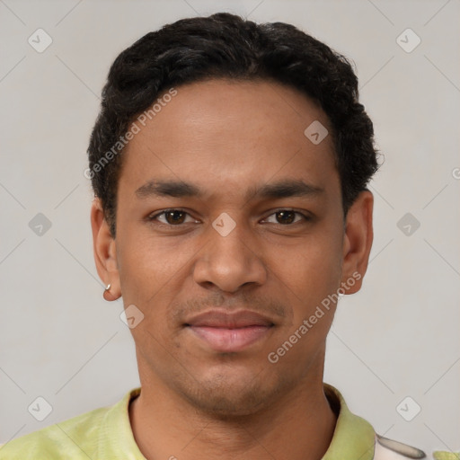 Joyful latino young-adult male with short  black hair and brown eyes