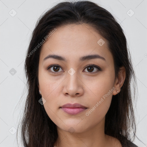 Joyful latino young-adult female with long  brown hair and brown eyes