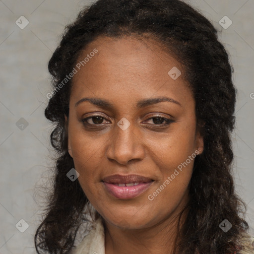 Joyful black adult female with long  brown hair and brown eyes