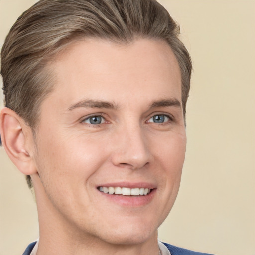 Joyful white young-adult male with short  brown hair and blue eyes