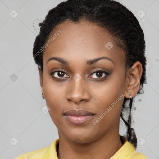 Joyful black young-adult female with short  black hair and brown eyes