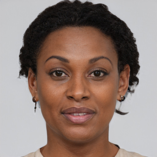 Joyful black adult female with short  brown hair and brown eyes