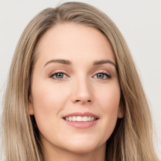 Joyful white young-adult female with long  brown hair and grey eyes