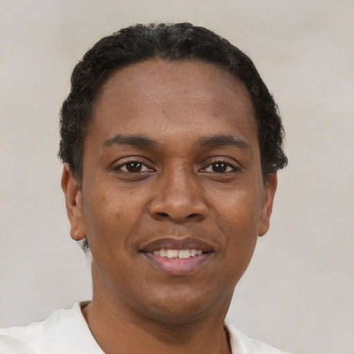 Joyful black young-adult male with short  black hair and brown eyes