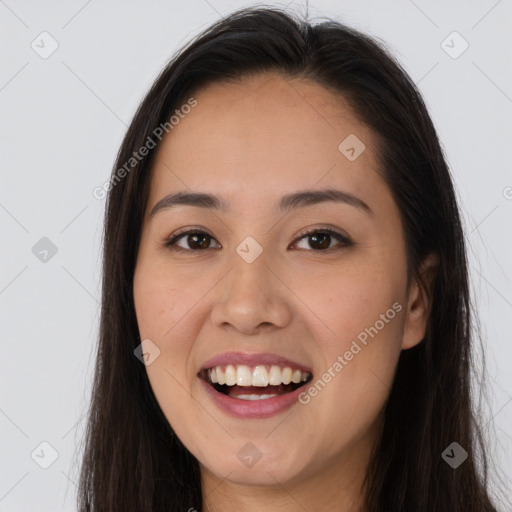 Joyful white young-adult female with long  brown hair and brown eyes