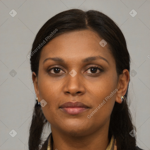 Joyful black young-adult female with long  brown hair and brown eyes